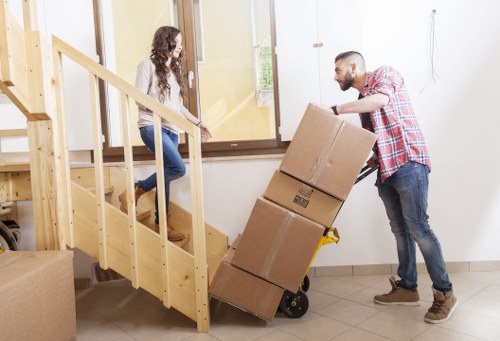 Specialist movers preparing a piano for transport at the start of a move